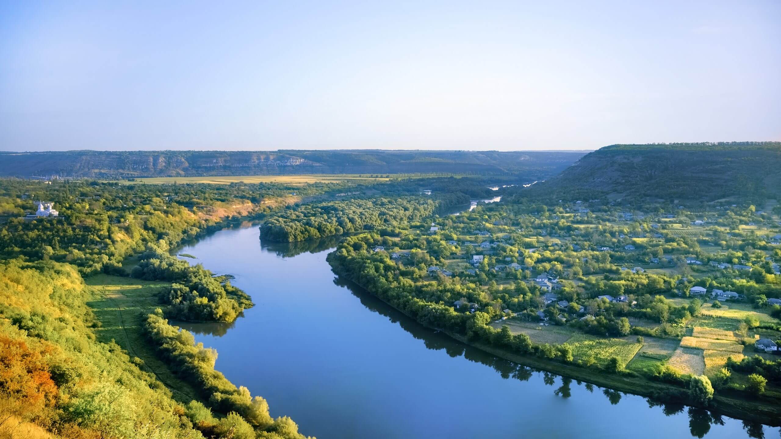 Village at sunrise in Moldova Zimmermann-Gruppe village with orthodox church river dividing into two parts scaled